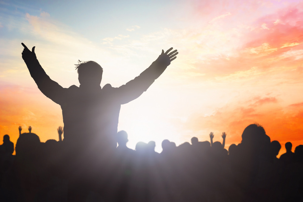 People worshipping together outdoors