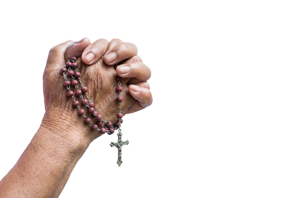 A rosary resting in open hands